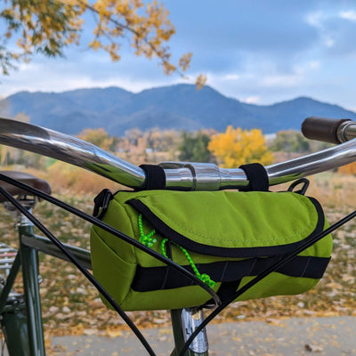 Handlebar bag by HandleStash on green bike. 