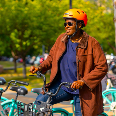 person on bike wearing xnito bike helmet in dutch colorway