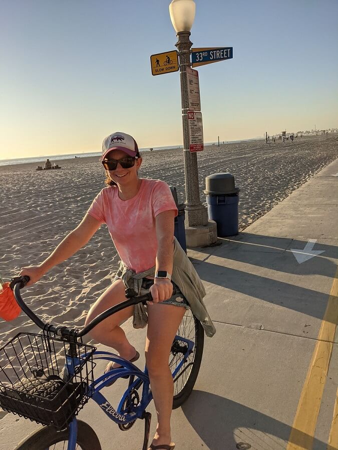 Woman riding bike on beach