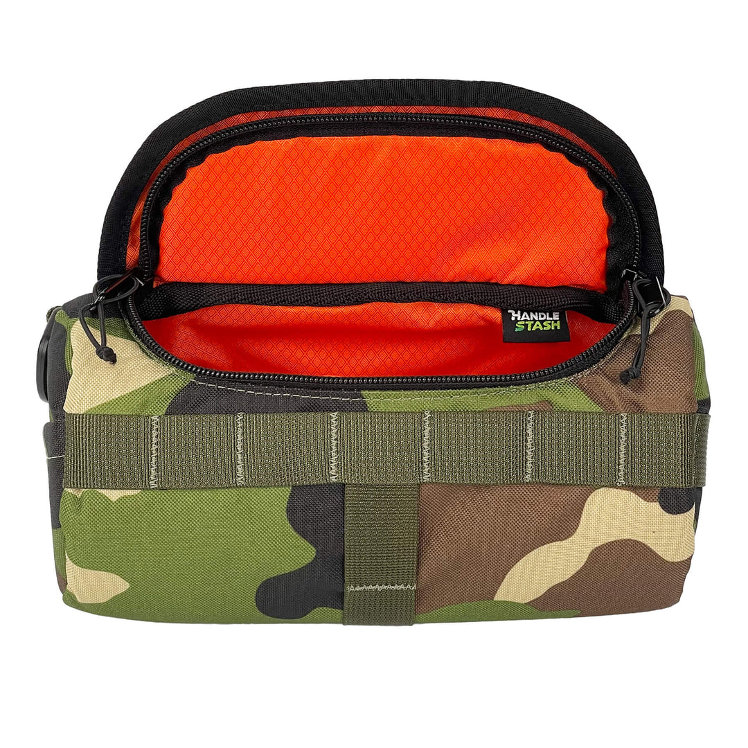 Camouflage HandleStash handlebar bag unzipped with blaze orange liner.