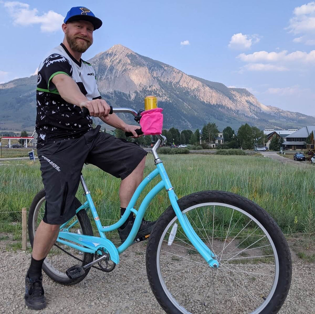 Handlestash owner with the best bike cup holder in pink and mountain background