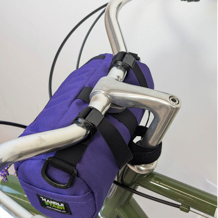 purple handlebar bag on white - on bike, back view