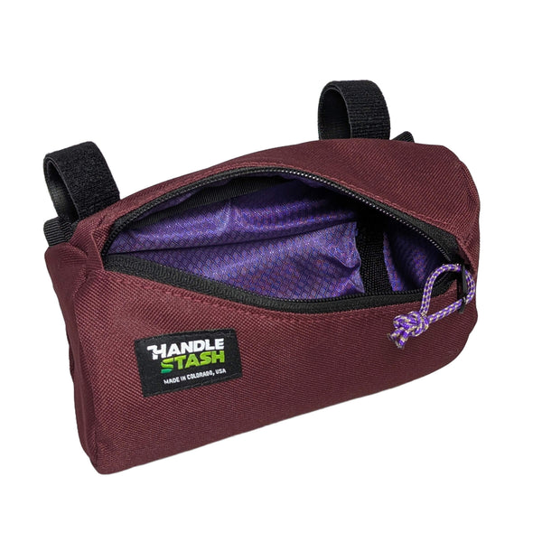 maroon Mini handlebar bag open to show purple liner