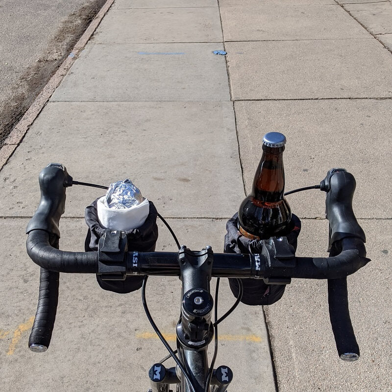 Road bike with two cup holders carrying a burrito and a beer