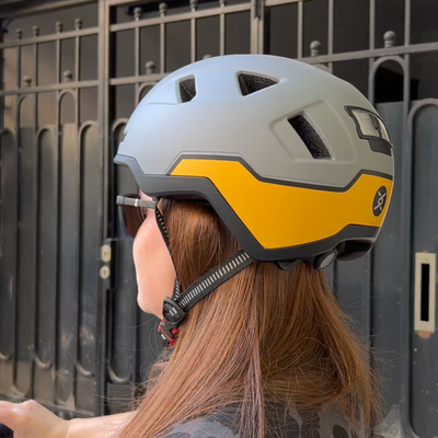 xnito ebike helmet on person's head - gull grey and yellow colorway