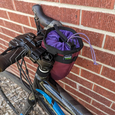 Purple handlestash stem bag on bike