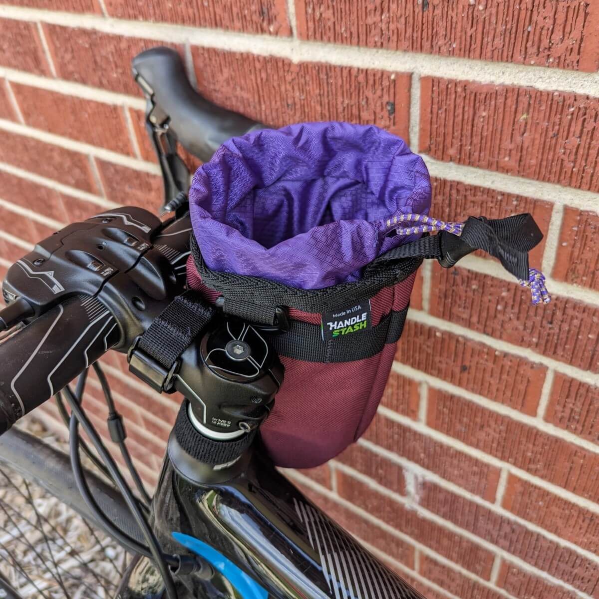 purple handlestash stem bag open on bike