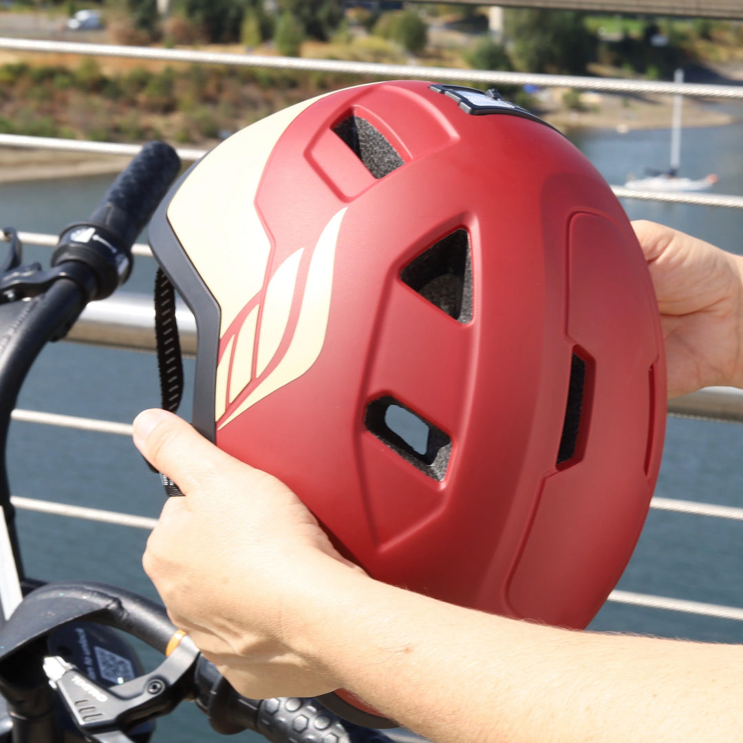 xnito ebike helmet in red color with wing being held by person