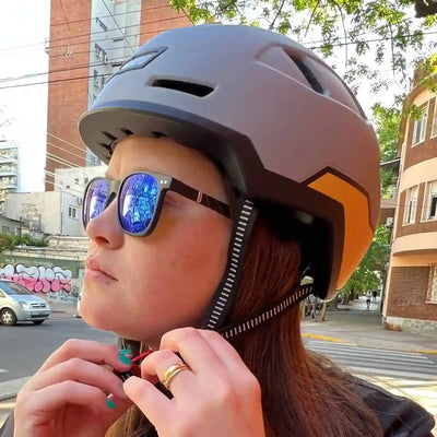 person closing fidlock strap on xnito ebike helmet
