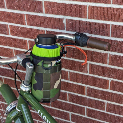 Camouflage bike stem bag with green liner on bicycle handlebars. 