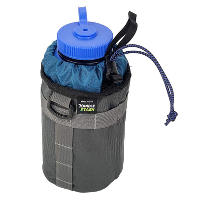 Charcoal stem bag with navy blue liner holding large water bottle. 