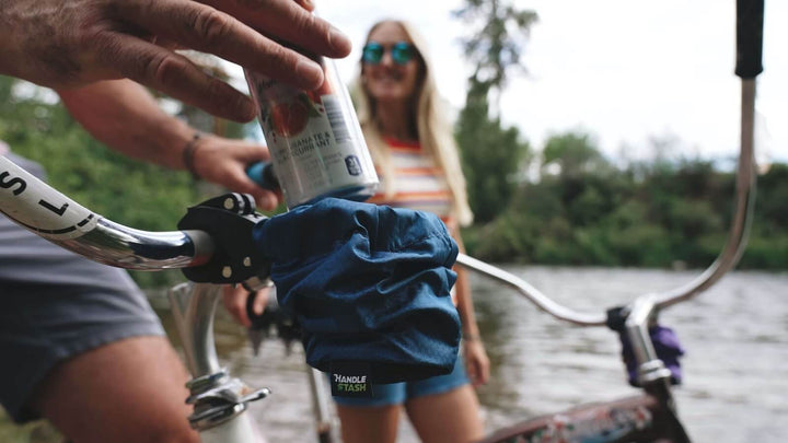 Can drinking from bike cup holder by river