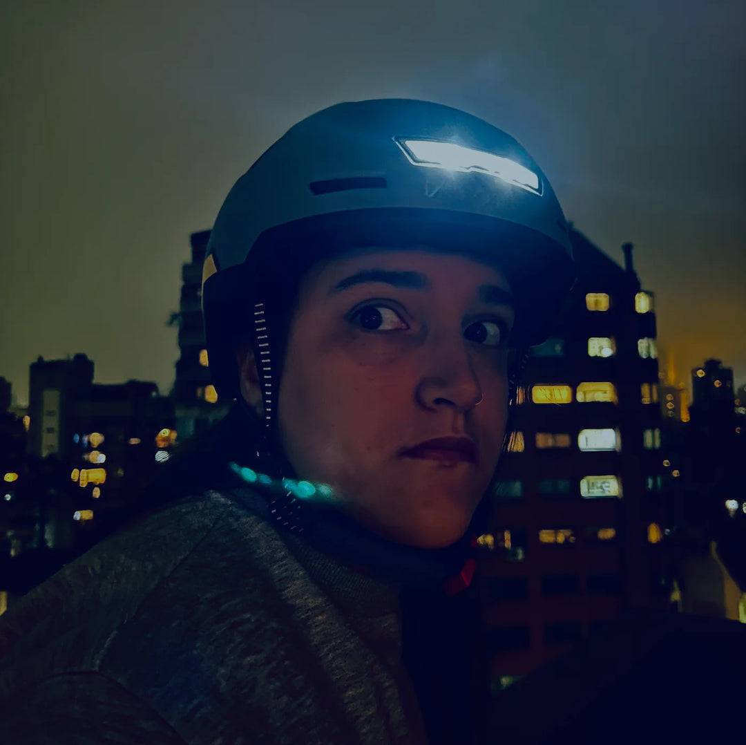 woman wearing ebike helmet with light and a very surprised look