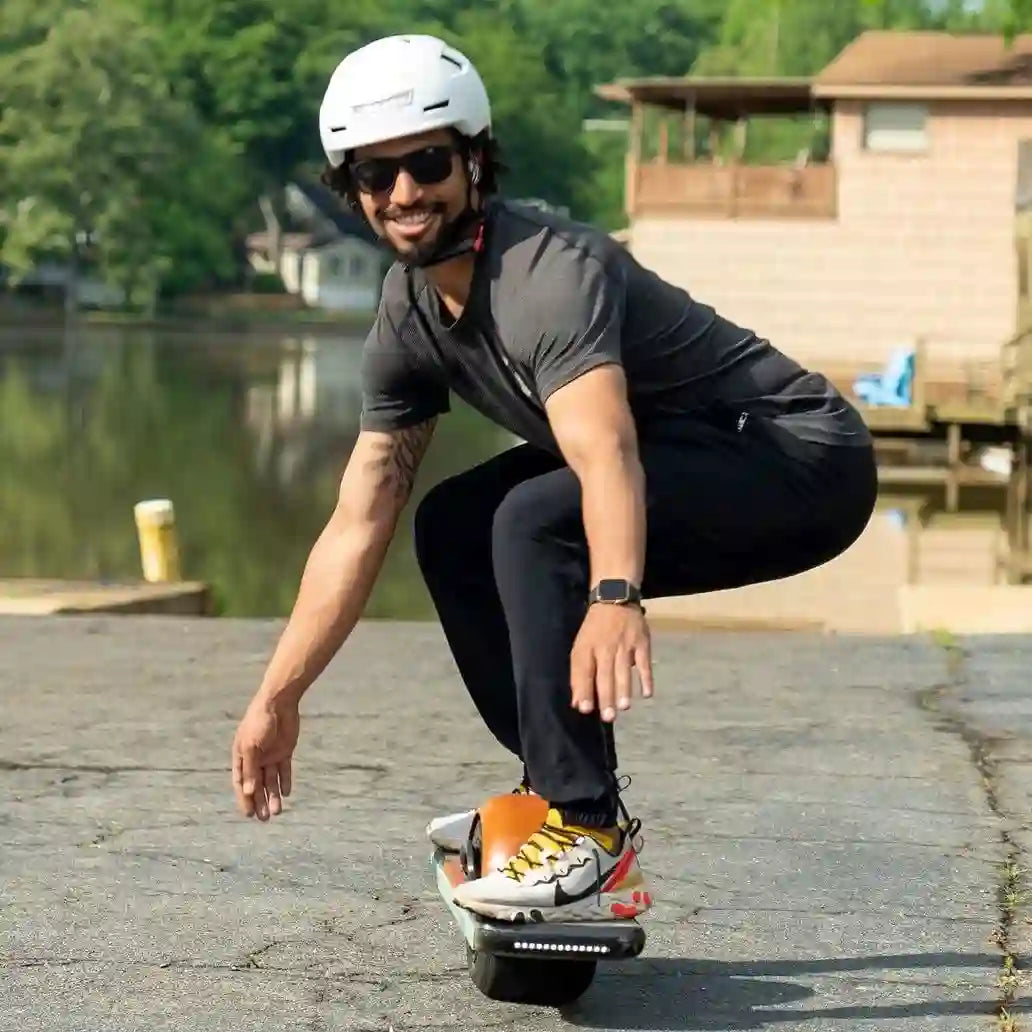 man wearing an xnito helmet riding a one-wheel very slowly