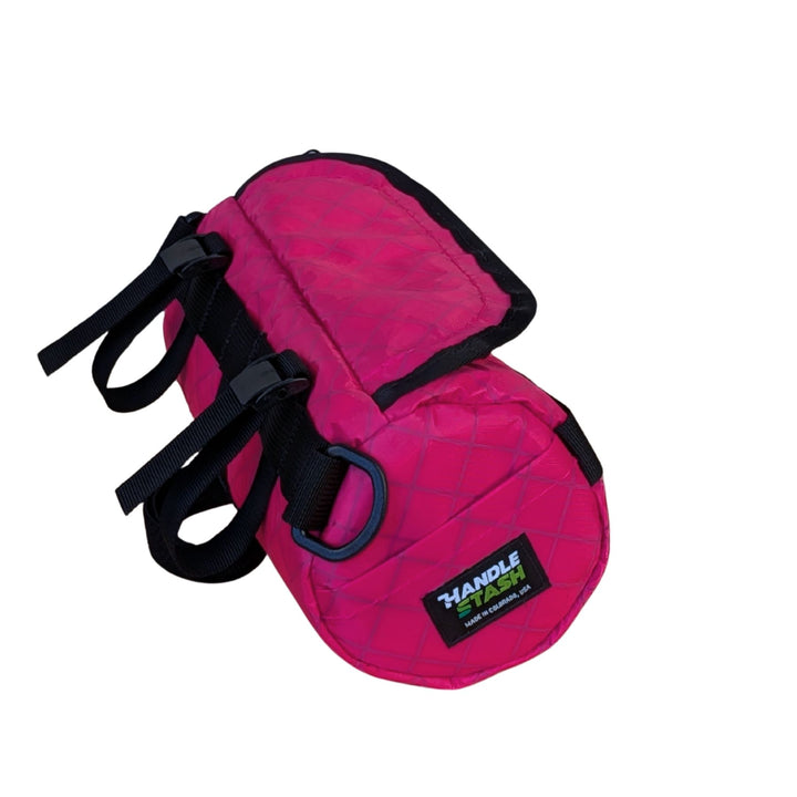 Pink ecopak bar bag with black straps on a white background showing side pocket