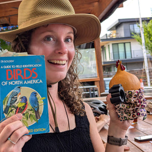 safari explorer holding a cat lady cup holder with a spherical chicken