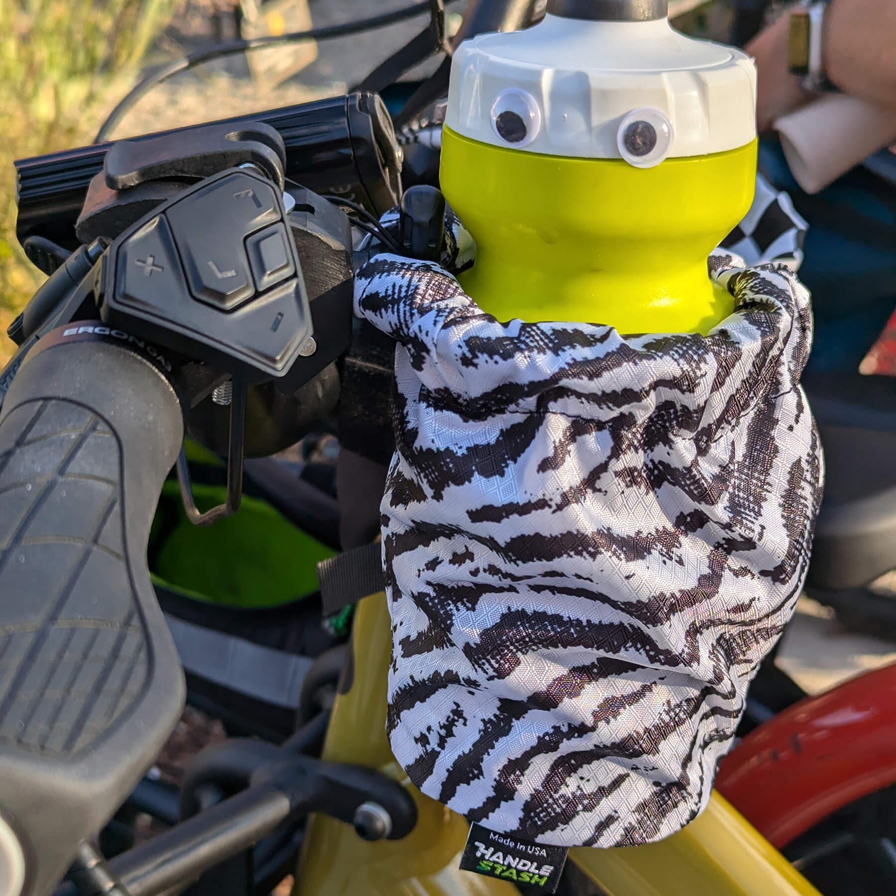 zebra cup holder with a water bottle with googly eyes