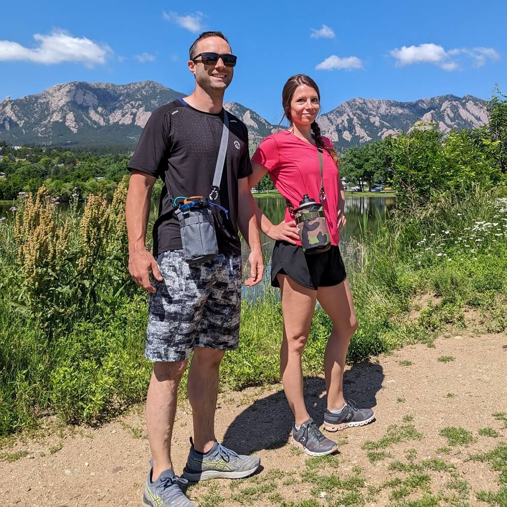 Couple wearing water bottle slings. 