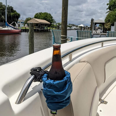 blue cup holder on boat rail holding a beer