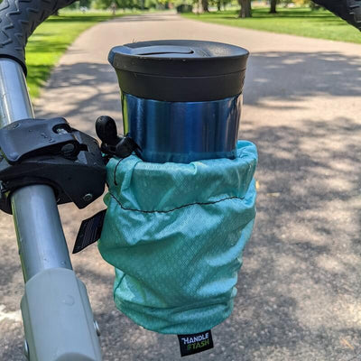 Teal HandleStash stroller cup holder with a coffee tumbler